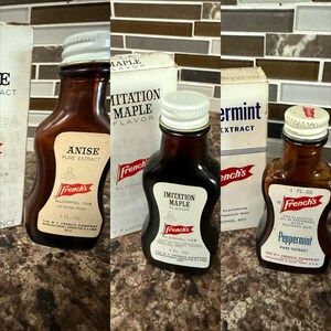 May include: Three vintage French's extract bottles with white labels and screw-on caps. The bottles contain Anise, Imitation Maple, and Peppermint extracts. The labels display the French's logo and product information. Each bottle is 1 fl oz.