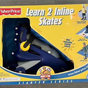 May include: Blue and yellow inline skates with removable training wheels. The box features the Fisher-Price logo and the text "Learn 2 Inline Skates". The box also includes the text "Grow to Pro Starter Series" and "www.fisher-price.com".