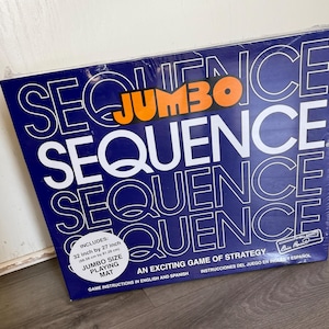 May include: A blue box for the game "Sequence" with the word "Jumbo" in orange. The box includes a 32 inch by 27 inch jumbo size playing mat. The text reads "An exciting game of strategy" and instructions are in English and Spanish.