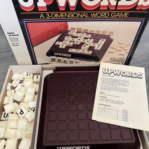 May include: A vintage board game called Upwords, a 3-dimensional word game. The game includes a brown game board with letter tiles, a letter distribution sheet, and instructions. The game is for 2-4 players.