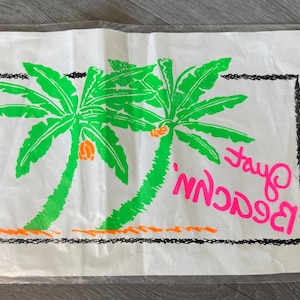 May include: White iron-on transfer with two green palm trees, orange coconuts, and the words "Fayo Beach" in pink. A black and green "TOPIX" neon iron-on transfer is next to it.