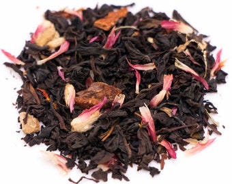 May include: A close-up of a blend of black tea leaves, dried fruit pieces, and flower petals. The tea blend is a mix of black tea, dried apple, dried hibiscus, and dried rose petals.