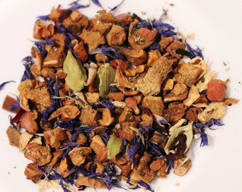 May include: A mix of dried fruit, herbs, and spices for tea. The mix includes apple, hibiscus, and cardamom.