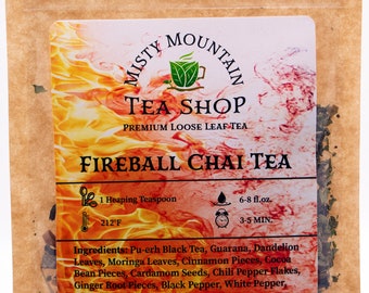 May include: A brown paper bag of Misty Mountain Tea Shop Fireball Chai Tea. The label features a fiery design and text detailing ingredients like Pu-erh tea and spices. Includes brewing instructions and the text "Contains Caffeine".