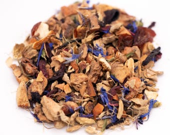 May include: A close-up of a pile of loose-leaf tea blend. The blend includes dried orange pieces, blue cornflowers, and other herbs and spices. The tea is a mix of brown, orange, red, and blue colors.