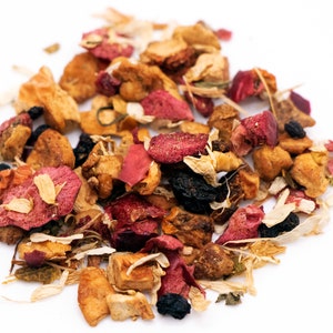 May include: A mix of dried fruit, flower petals, and herbs for tea. The mix includes dried apple pieces, red and pink flower petals, and small black berries.
