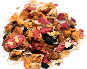 May include: A mix of dried fruit, flower petals, and herbs for tea. The mix includes dried apple pieces, red and pink flower petals, and small black berries.
