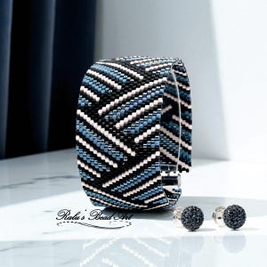May include: A wide beaded bracelet with a chevron pattern in black, white, and shades of blue. Two matching round, dark blue beaded cufflinks are next to the bracelet. The text "Ralu's Bead Art" is at the bottom.