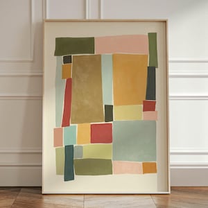 Pode incluir: Impressão de arte abstrata com um design geométrico que apresenta várias cores, incluindo verde, amarelo, vermelho, azul e rosa. A impressão é emoldurada em uma moldura de madeira simples.