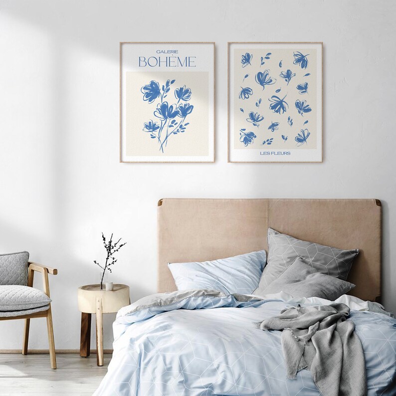 May include: Two framed prints with blue floral illustrations on a cream background. The print on the left has the text "GALERIE BOHEME" and the print on the right has the text "LES FLEURS".