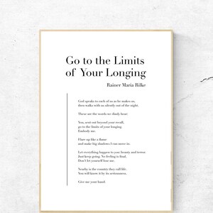 May include: A framed print with a white background and black text. The text reads "Go to the Limits of Your Longing" by Rainer Maria Rilke. The poem is about pushing your boundaries and embracing the unknown.