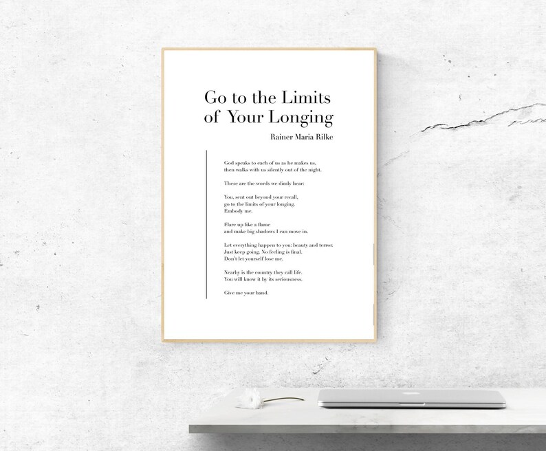 May include: A framed print with a white background and black text. The text reads "Go to the Limits of Your Longing" by Rainer Maria Rilke. The poem is about pushing your boundaries and embracing the unknown.