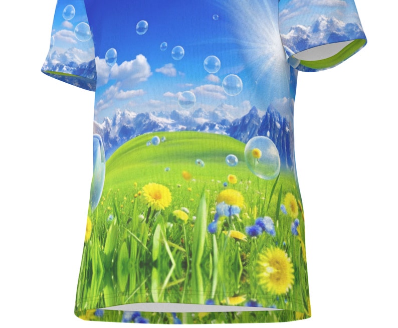 May include: A blue and green t-shirt featuring a graphic print of a field of dandelions and bubbles floating over a mountain range.