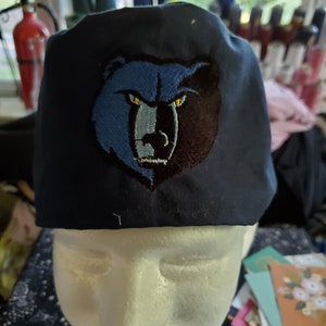 Grizzly tie back scrub hat on navy fabric and more