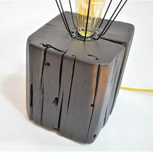 Loft black lamp from an old beam. A table lamp made of old wood. A lamp made of solid wood with an industrial lampshade