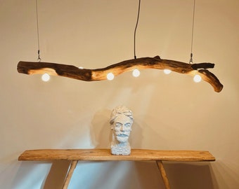 A stylish and unique wooden hanging lamp made of a thick natural oak branch. Small milky ball bulbs. Natural warm LED light