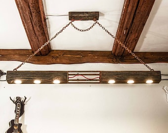 A long wooden beam lamp hanging on chains in an industrial style. A unique wooden chandelier with 6 LED bulbs, handmade