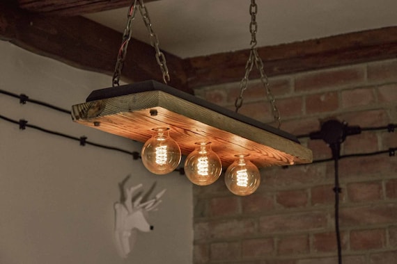 A Wooden Ceiling Lamp Made From Old Boards, Hanging on Chains