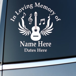 May include: White vinyl decal with a guitar, wings, and musical notes. The text reads "In Loving Memory of Name Here Dates Here".