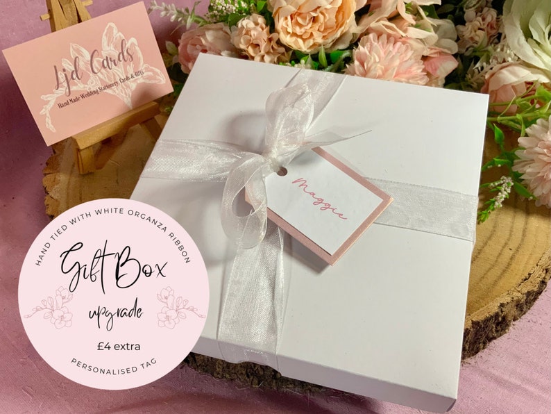 white 6x6 card gift box tied with white organza ribbon and personalised name tag