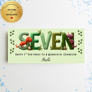 May include: A rectangular light green sign featuring the word SEVEN in large 3D letters decorated with ferns, dinosaur eggs, a red T-Rex, and a purple triceratops. Text reads: HAPPY 7TH BIRTHDAY TO A WONDERFUL GRANDSON and the name Gabe.