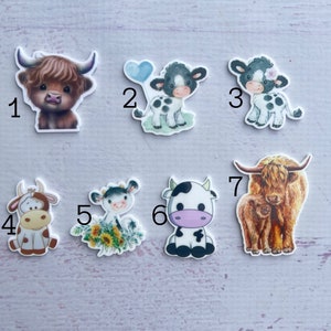 May include: Set of 7 cow and highland cow themed resin embellishments. The embellishments are in various colours, including brown, black, white, and pink. The embellishments are perfect for adding a touch of whimsy to your crafts.