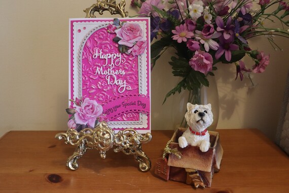 Handmade Mother’s Day Card embellished with die cut pink roses on an embossed arch background with fancy die cut sentiment