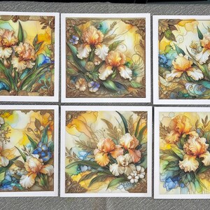 May include: Six square cards with white borders and gold accents. Each card features a watercolour painting of a bouquet of yellow and white irises with green leaves and blue accents.
