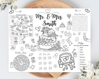 May include: A black and white wedding activity placemat with the names "Mr. & Mrs. Smith" and the phrase "Happily ever after." The placemat includes a maze, tic-tac-toe, and a word search, along with other wedding-themed games.