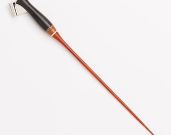 May include: An oblique calligraphy pen holder featuring a dark brown, polished wooden grip section, a slender reddish-brown tapered body, and a metallic silver flange at the top designed to hold a nib for writing and lettering tasks.