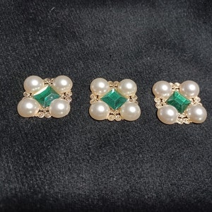 Regal ouches with green stone