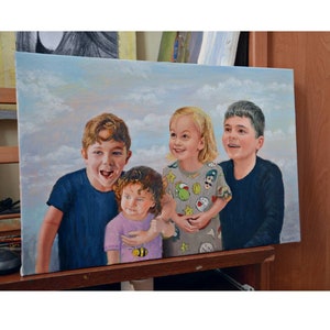 May include: Oil painting of four children, smiling and looking towards the viewer. The children are wearing various colored shirts, set against a sky background with clouds. The artwork is displayed on an easel.