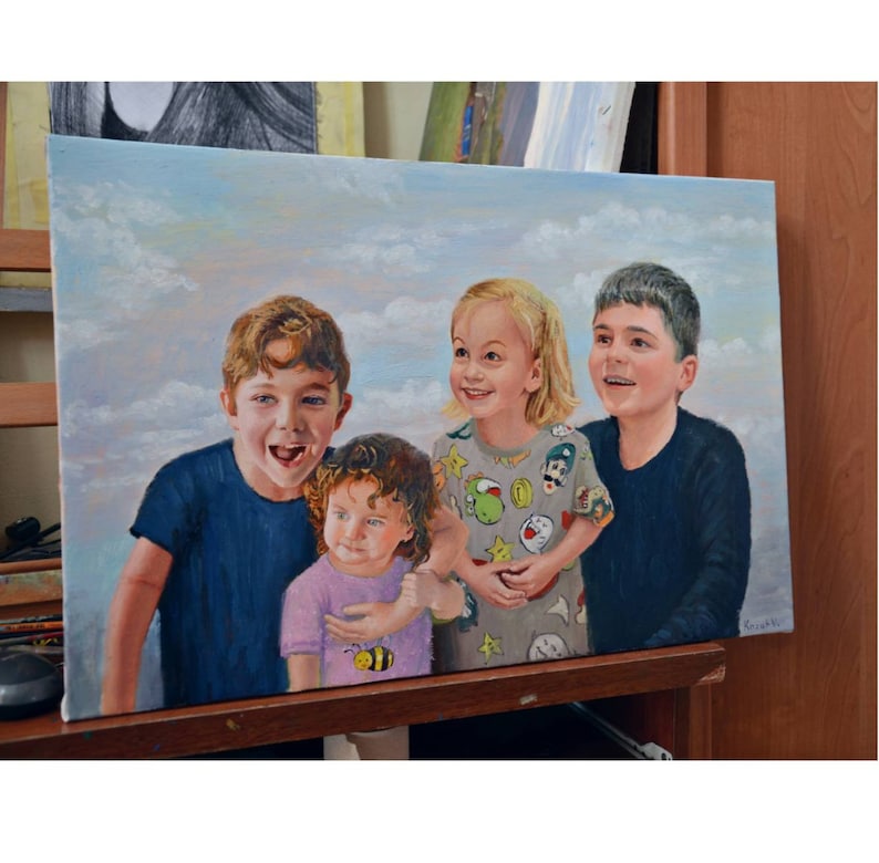 May include: Oil painting of four children, smiling and looking towards the viewer. The children are wearing various colored shirts, set against a sky background with clouds. The artwork is displayed on an easel.