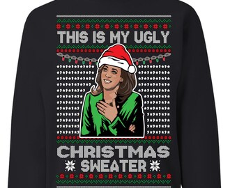 May include: Black Christmas sweater with a green and white snowflake pattern. It features a portrait of a woman wearing a Santa hat and a green sweater with the text "This is my ugly Christmas sweater".