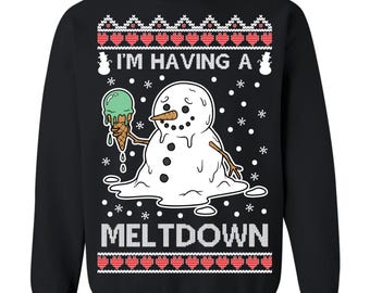 May include: Black sweatshirt with a melting snowman graphic holding a green ice cream cone. The text "I'M HAVING A MELTDOWN" is displayed below the snowman. The design includes snowflakes and a red and white pattern.