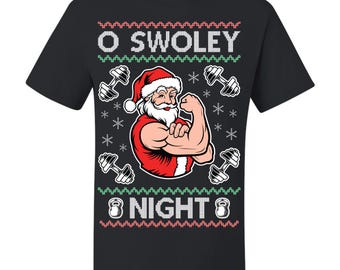 May include: Black t-shirt with a festive design featuring Santa Claus flexing his bicep. The text "O Swoley Night" is displayed above and below the Santa illustration, with dumbbell and snowflake graphics.