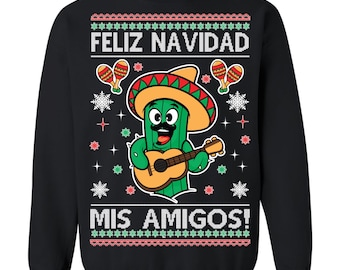 May include: Black sweatshirt with a festive design. It features a cactus wearing a sombrero and playing a guitar, with the text "FELIZ NAVIDAD MIS AMIGOS!" above and below the cactus. The design includes maracas, snowflakes, and star accents.