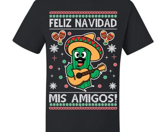 May include: Black t-shirt with a festive design featuring a cactus wearing a sombrero and playing a guitar. The shirt includes the text "FELIZ NAVIDAD MIS AMIGOS!" in white, red, and green colors. The design has a sweater-like appearance.