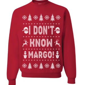 May include: Red Christmas sweater with a white knit pattern featuring snowflakes, Christmas trees, Santa Claus, reindeer, and a snowman. The sweater has the text "I DON'T KNOW MARGO!" in white.