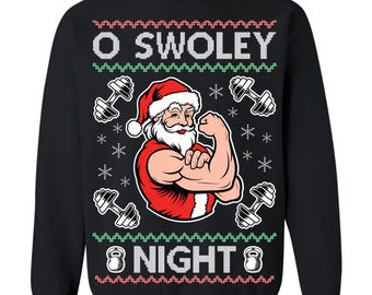 May include: Black sweatshirt with a festive design featuring a flexing Santa Claus wearing a red Santa hat and vest. The text "O SWOLEY 8 NIGHT 8" is displayed in white and red, along with dumbbell graphics and snowflakes.