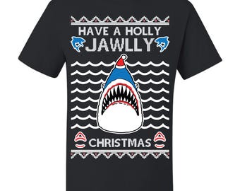 May include: Black t-shirt with a festive design featuring a shark wearing a Santa hat. The shirt includes the text "Have a Holly Jawlly Christmas" with wave and snowflake patterns.
