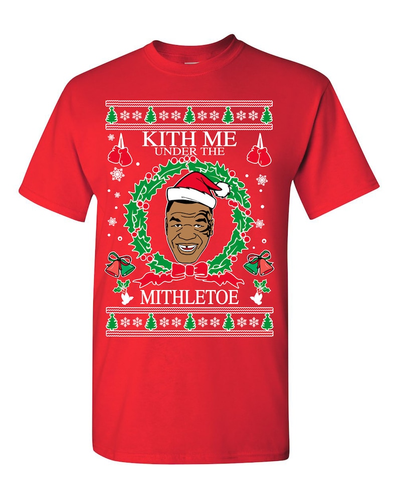 Pode incluir: Camisola vermelha de Natal com uma grinalda verde, uma imagem de um homem a usar um chap&eacute;u de Pai Natal e o texto "Kith Me Under The Mithletoe".