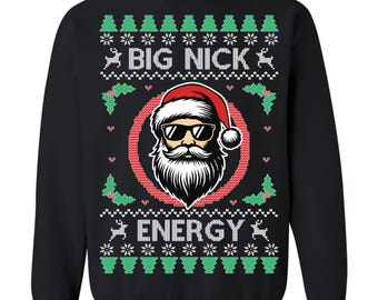 May include: Black sweatshirt with a festive design. The graphic features a Santa Claus wearing sunglasses and a red hat, surrounded by a red circle. The text "BIG NICK ENERGY" is displayed above and below the Santa image, with snowflakes, trees, and reindeer.