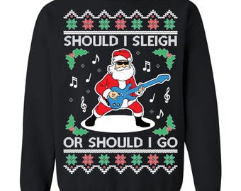 May include: Black sweatshirt with a Santa Claus graphic playing a blue guitar. The text "SHOULD I SLEIGH OR SHOULD I GO" is printed above and below the Santa graphic. The design includes musical notes and Christmas-themed patterns.