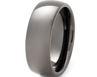 May include: A dark gray ceramic wedding band with a polished finish and a black inner band.