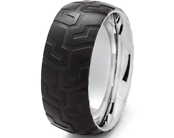 May include: A black and silver patterned wedding band with a textured finish.