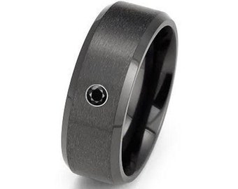 May include: A black brushed metal ring with a single black gemstone set in the center.