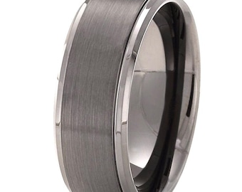 May include: A dark gray metal ring featuring a brushed matte finish on the outer band and polished, reflective beveled edges. The band has a wide, flat profile with a smooth, metallic texture and a high-contrast appearance between the center and sides.
