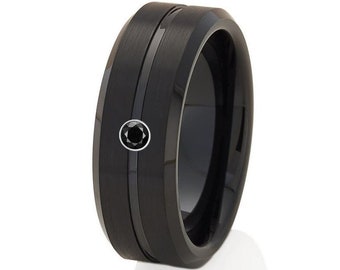 May include: A black tungsten carbide ring with a black diamond inlay and a brushed finish.