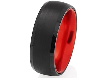 May include: A black tungsten carbide ring with a red interior. The ring has a brushed finish.